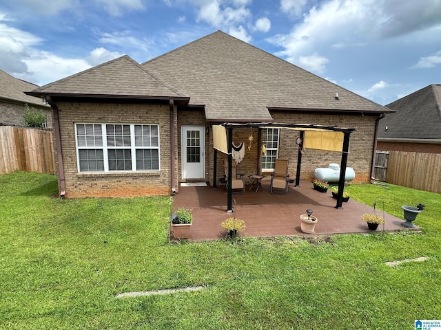 back of house with a patio area and a lawn