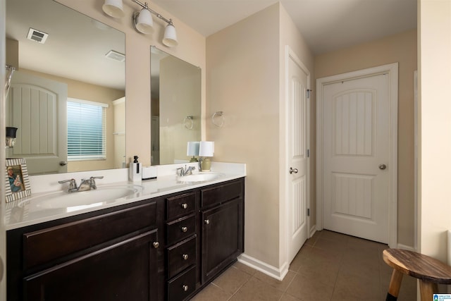 bathroom featuring tile patterned flooring and vanity