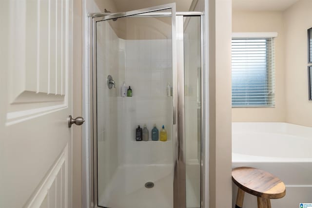 bathroom with shower with separate bathtub