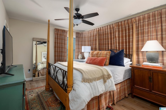 bedroom featuring hardwood / wood-style floors and ceiling fan