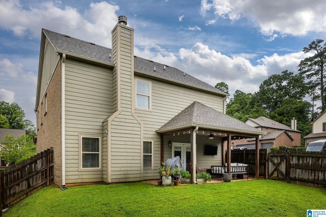 back of house with ceiling fan, a yard, and a patio area