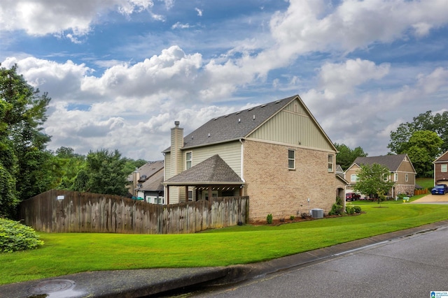 view of property exterior with central AC unit and a lawn