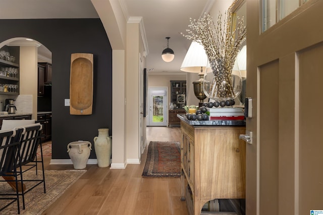 kitchen with wood-type flooring and crown molding