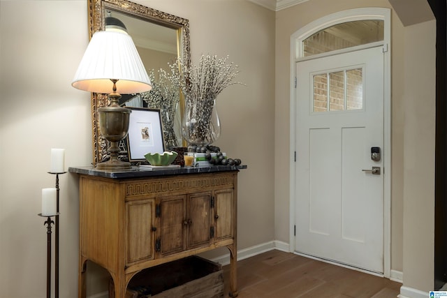 foyer entrance featuring dark hardwood / wood-style flooring and crown molding