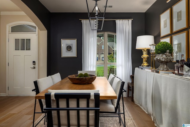 dining room featuring an inviting chandelier and light wood-type flooring