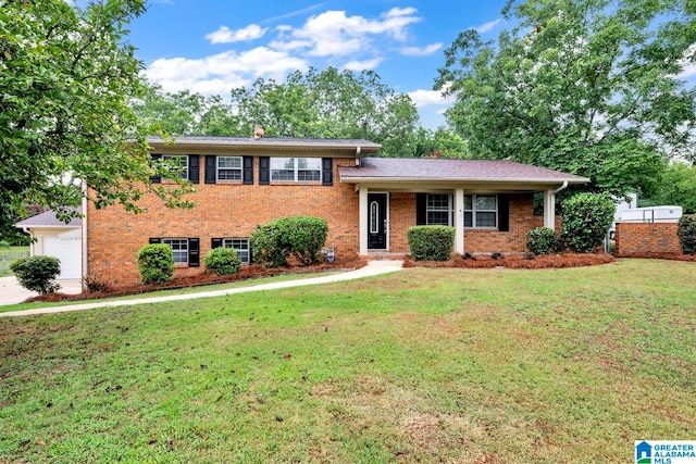 split level home with a garage and a front yard