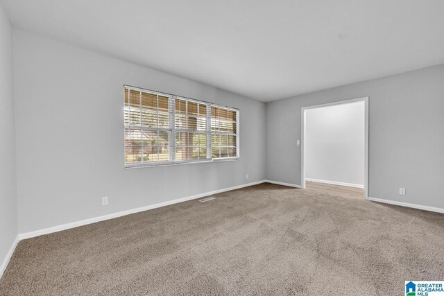 unfurnished room with carpet flooring