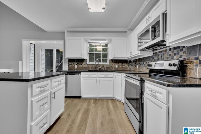 kitchen with sink, light hardwood / wood-style flooring, white cabinets, and stainless steel appliances