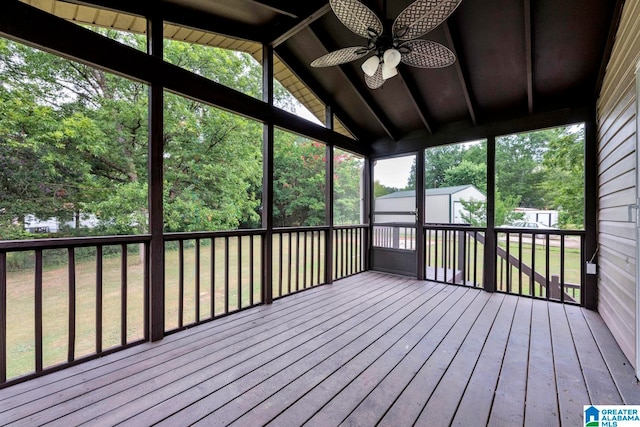 unfurnished sunroom featuring a healthy amount of sunlight, vaulted ceiling, and ceiling fan