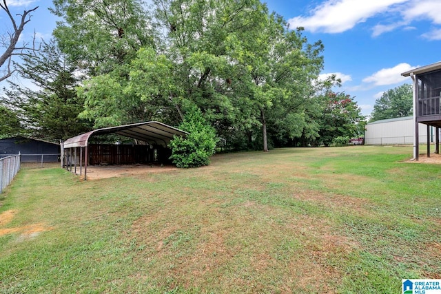 view of yard with a carport and a sunroom