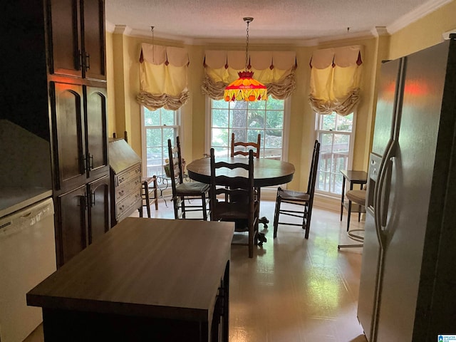 dining room featuring ornamental molding and a textured ceiling