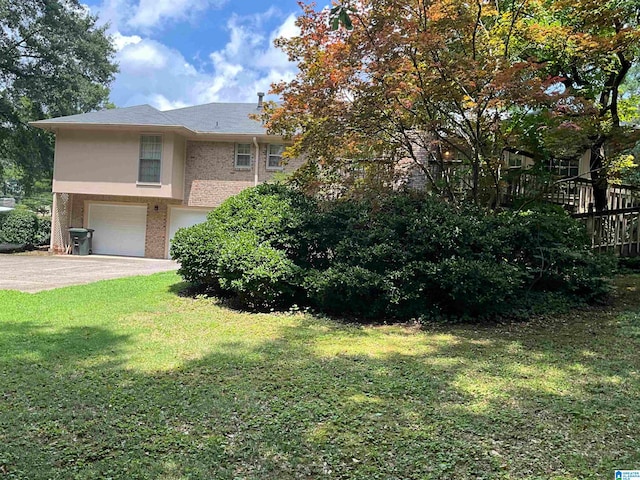 view of front of house with a garage and a front lawn