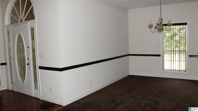 entrance foyer featuring crown molding, a notable chandelier, and baseboards