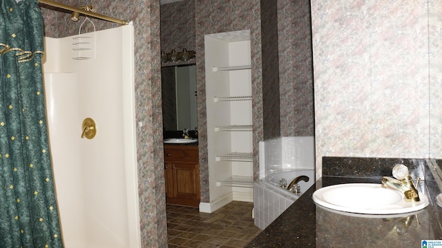 full bath with a shower, vanity, a bath, and tile patterned floors