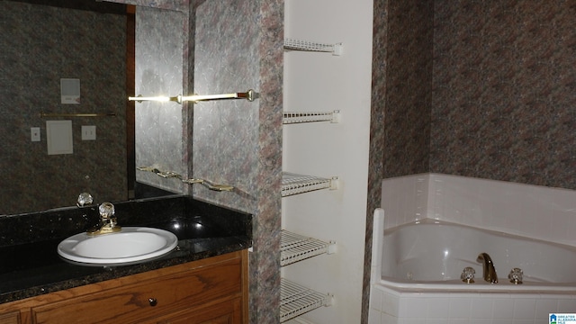 full bath with a tub and vanity