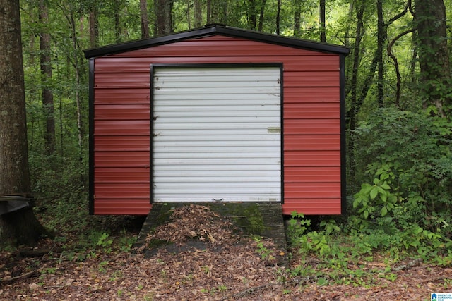 view of outbuilding featuring an outbuilding and a view of trees