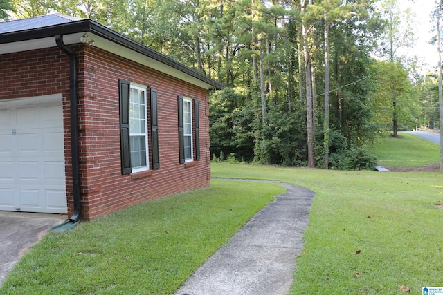 view of property exterior with an attached garage, a lawn, and brick siding