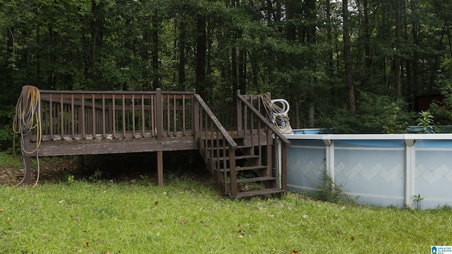 exterior space with a wooden deck and a lawn