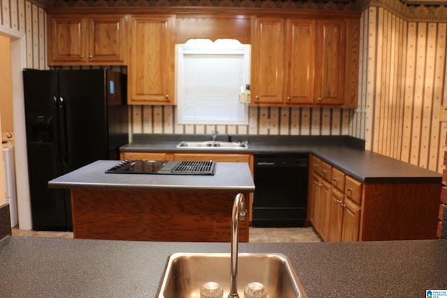 kitchen featuring wallpapered walls, black appliances, and a sink