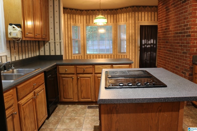 kitchen with dark countertops, brick wall, brown cabinets, black appliances, and a sink