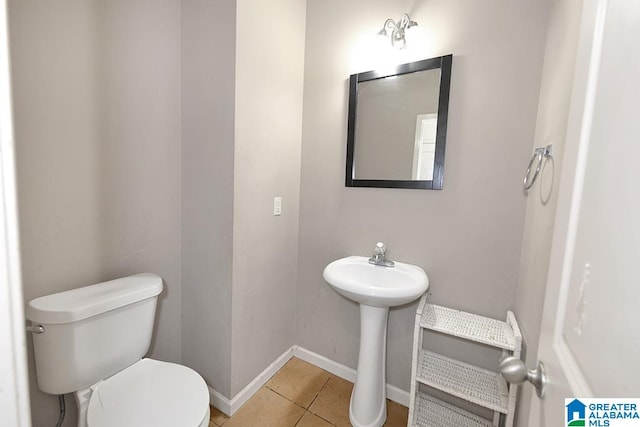 bathroom featuring toilet and tile patterned flooring