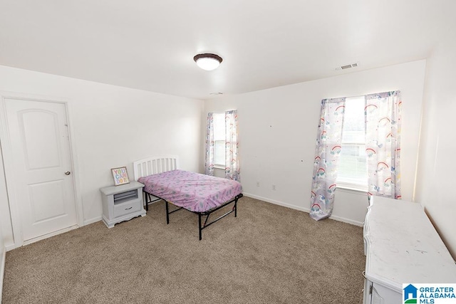 bedroom featuring light colored carpet