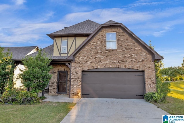 view of front of property with a garage and a front lawn