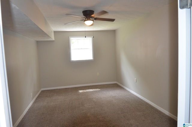 unfurnished room featuring ceiling fan and carpet flooring