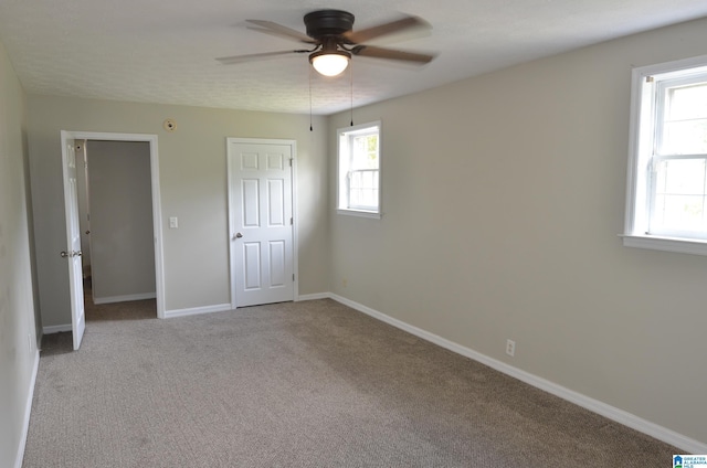 unfurnished bedroom featuring ceiling fan and light colored carpet