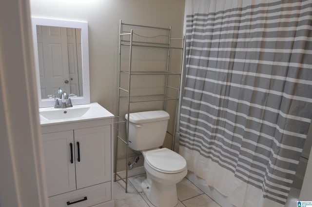 bathroom featuring vanity, toilet, and tile patterned flooring