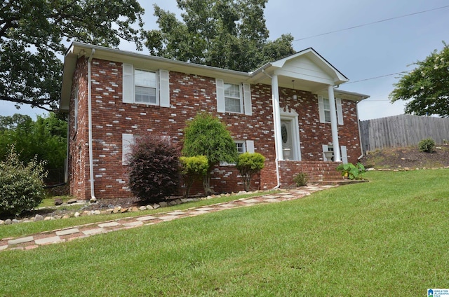 raised ranch with a front lawn