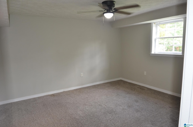 empty room with ceiling fan, a textured ceiling, and carpet flooring