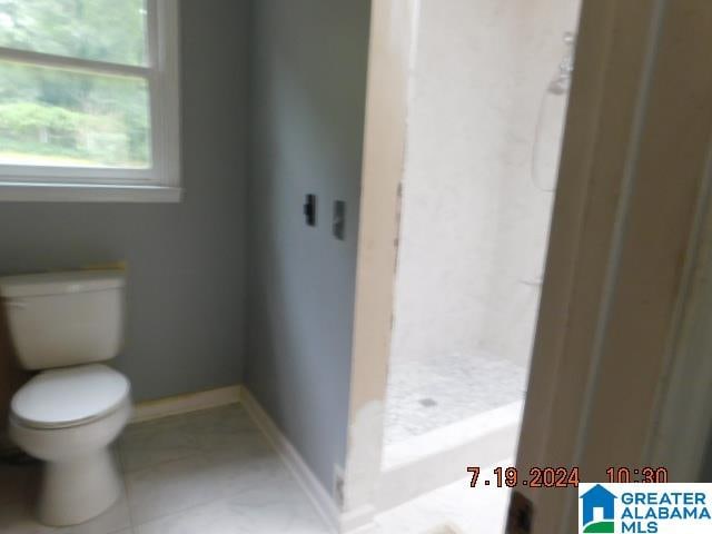 bathroom with tile patterned floors and toilet