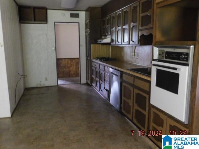 kitchen featuring appliances with stainless steel finishes, tasteful backsplash, and extractor fan