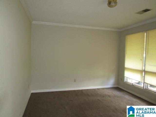 carpeted spare room with ornamental molding