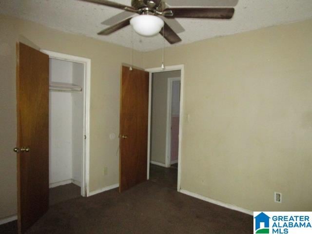 unfurnished bedroom featuring carpet, a closet, and ceiling fan