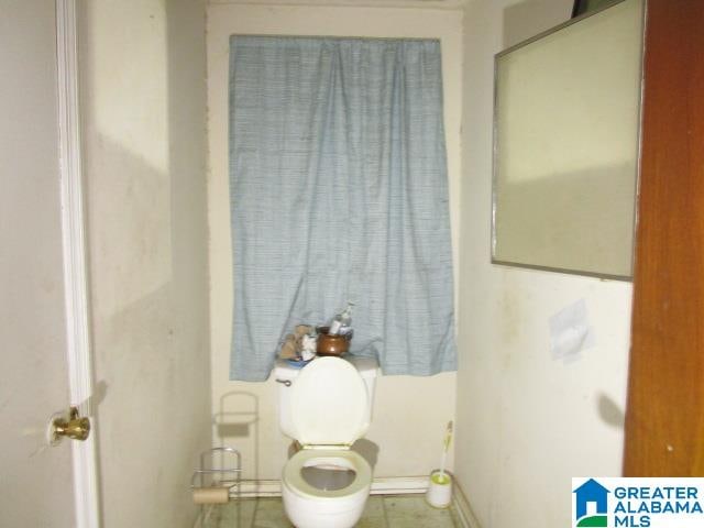 bathroom featuring toilet and tile patterned floors