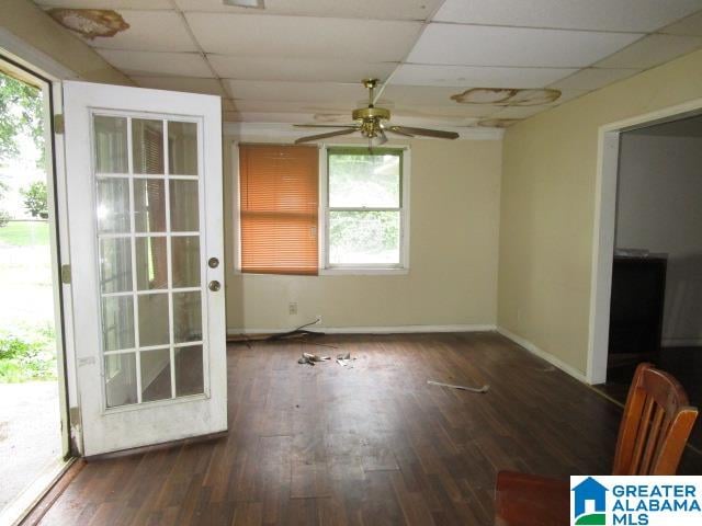 unfurnished room featuring a healthy amount of sunlight, hardwood / wood-style flooring, and a drop ceiling