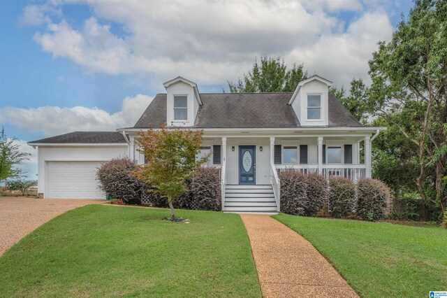 cape cod-style house featuring a front yard, covered porch, and a garage