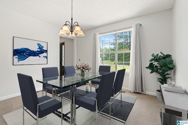 carpeted dining room with a chandelier and a textured ceiling