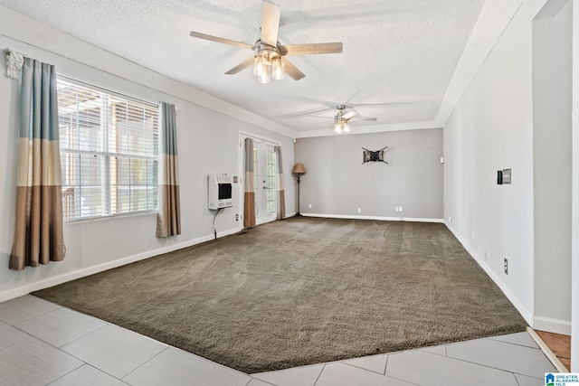 spare room featuring tile patterned flooring, a textured ceiling, heating unit, and ceiling fan