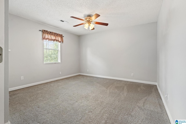 carpeted empty room with ceiling fan and a textured ceiling