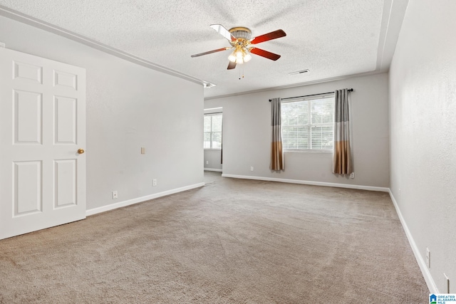 carpeted spare room with ceiling fan and a textured ceiling