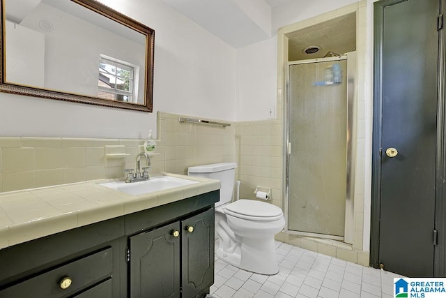 bathroom featuring walk in shower, backsplash, toilet, vanity, and tile walls