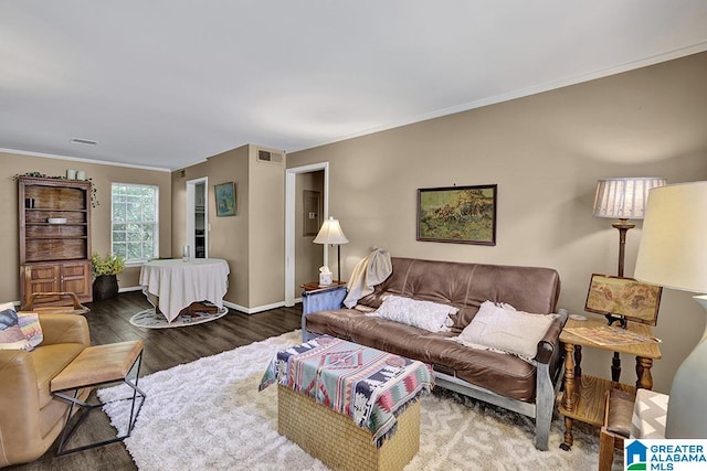 living room featuring hardwood / wood-style flooring and crown molding