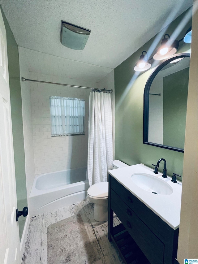 full bathroom with toilet, shower / tub combo, a textured ceiling, and vanity