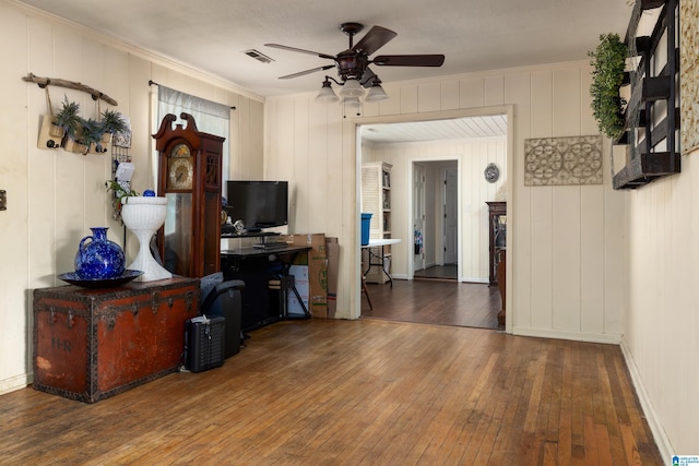 living room with ceiling fan, dark hardwood / wood-style flooring, and ornamental molding