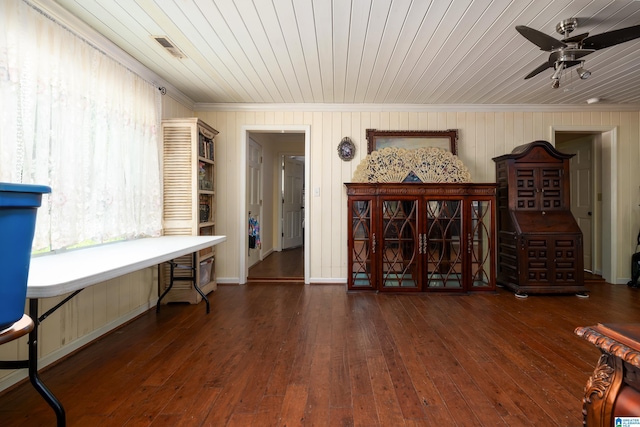 sitting room with dark wood-type flooring, crown molding, plenty of natural light, and wood ceiling