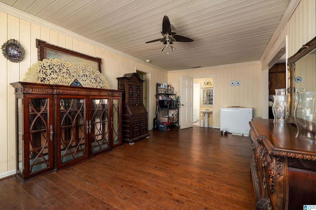 interior space with ceiling fan, dark wood-type flooring, and crown molding