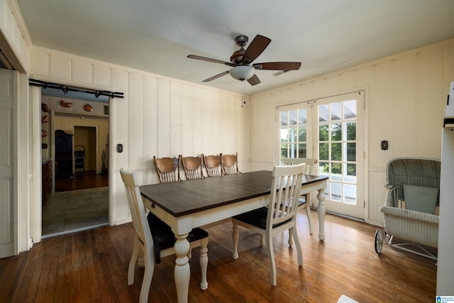 dining space with ceiling fan and dark hardwood / wood-style flooring